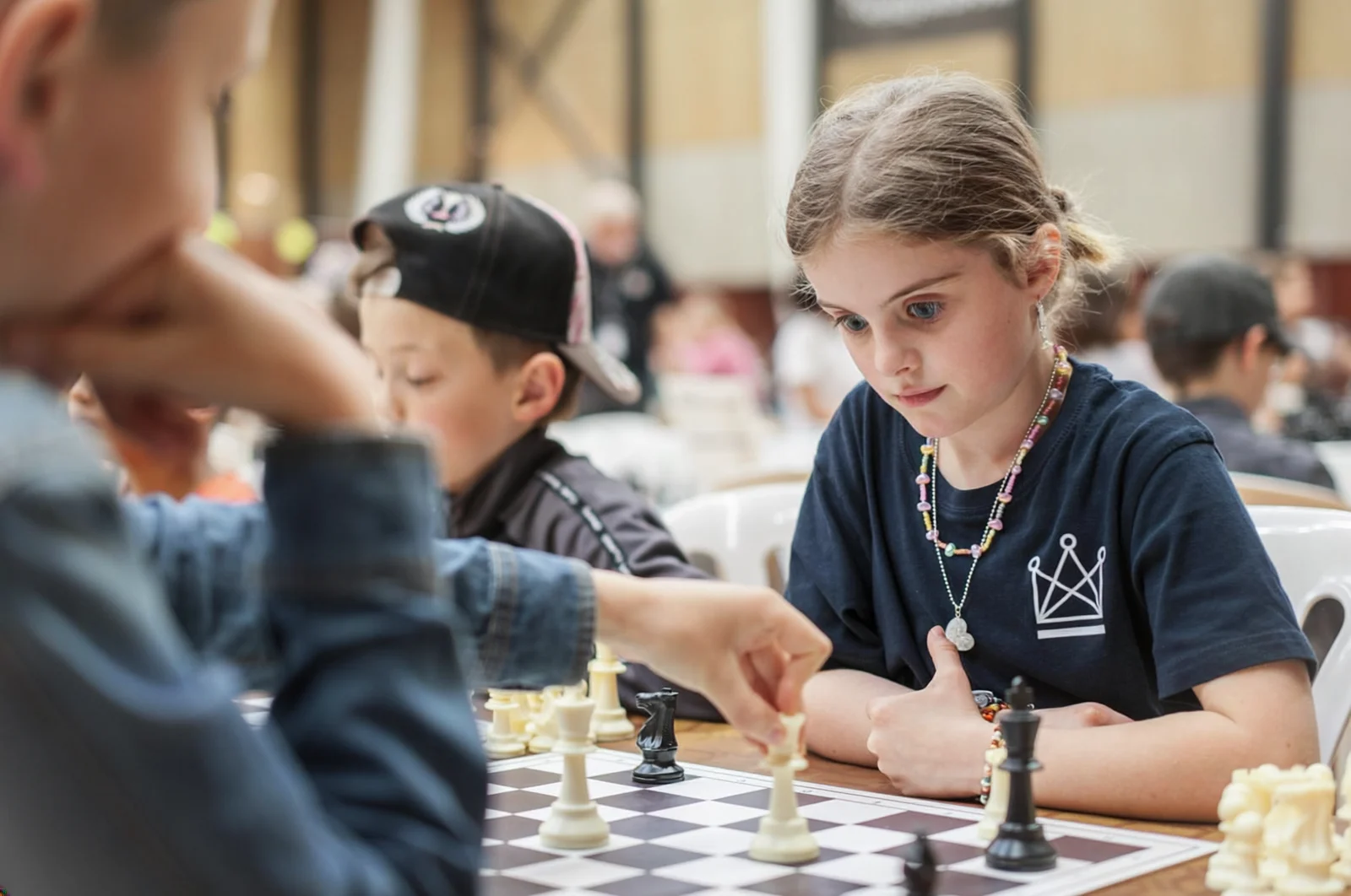 Children practising chess-based learning Children concentrating on a chess game during a learning activity.