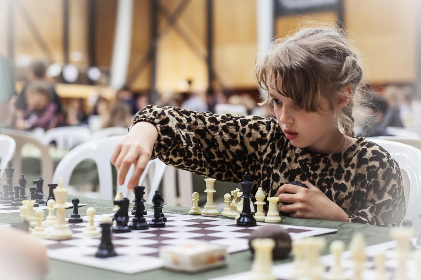 Child concentrating on a chess move A child concentrating on a chess move during a learning activity.